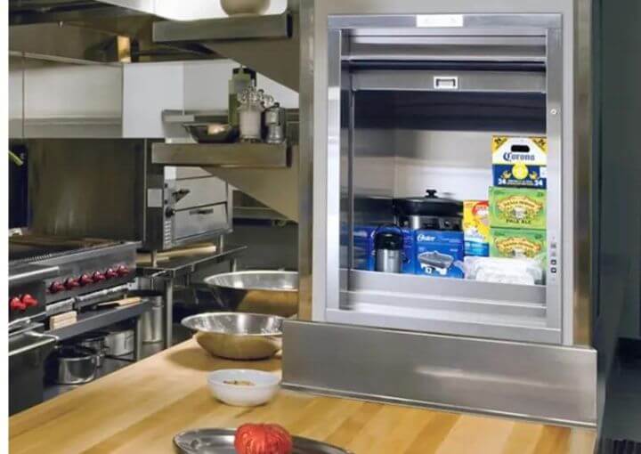 Food items are arranged inside a Cable-Driven Dumbwaiter elevator for efficient transportation.