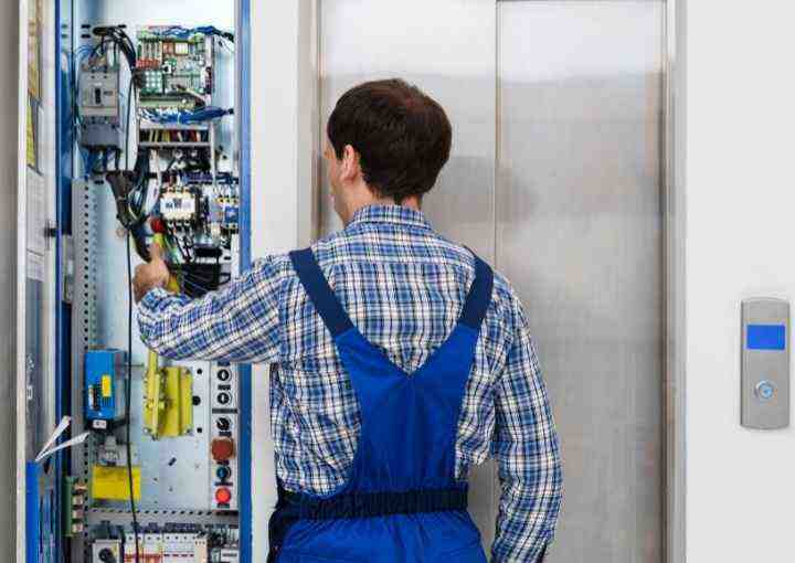 Diligent Royal Fuji Staff Managing Passenger Elevator Inspection for Safety and Performance.