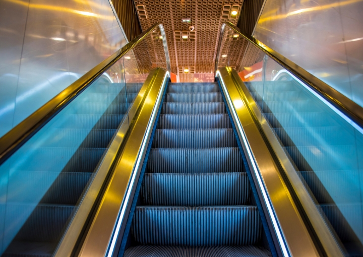 A Royal Fuji escalator in a busy shopping mall, smoothly transporting people between floors.