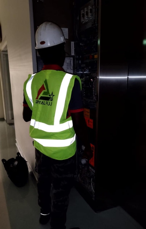 Royal Fuji staff installing an elevator in a building.